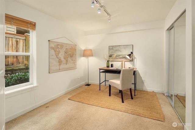 home office featuring track lighting and carpet