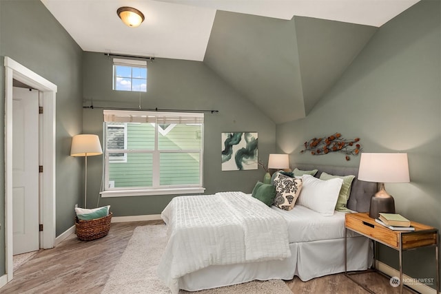 bedroom featuring lofted ceiling and hardwood / wood-style floors