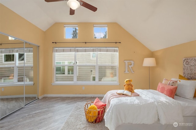 bedroom with hardwood / wood-style flooring, vaulted ceiling, and ceiling fan