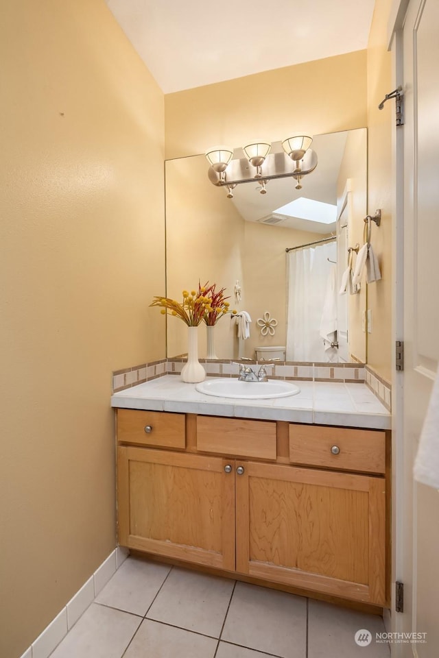 bathroom with vanity and tile patterned flooring