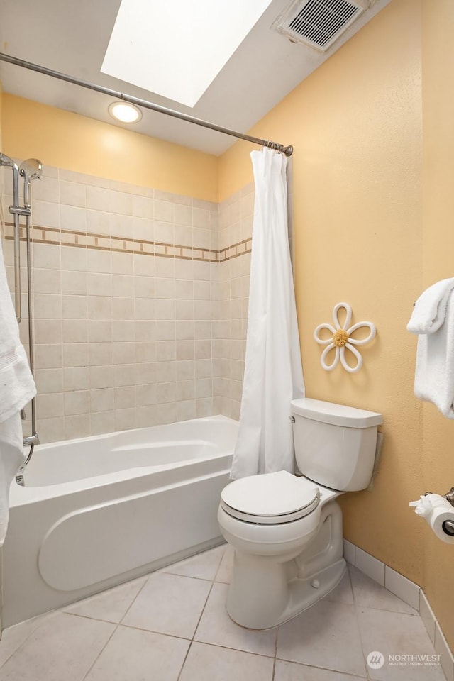 bathroom with tile patterned flooring, a skylight, toilet, and shower / bathtub combination with curtain