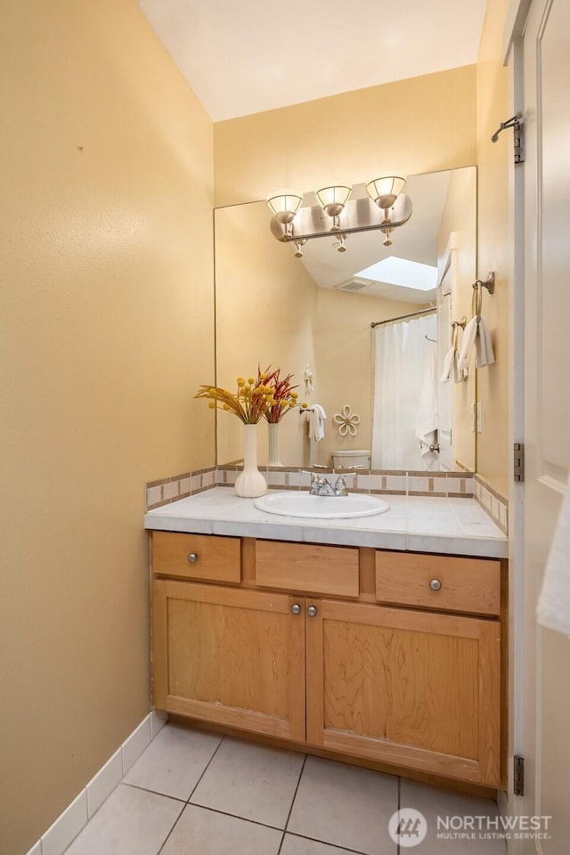 bathroom with vanity and tile patterned flooring