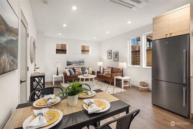 dining space with light hardwood / wood-style flooring