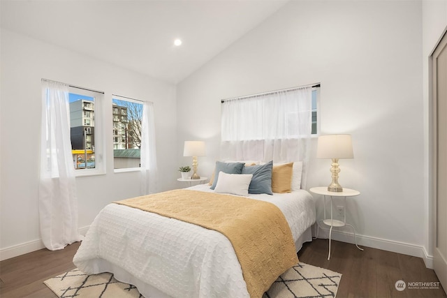 bedroom featuring dark hardwood / wood-style floors and high vaulted ceiling