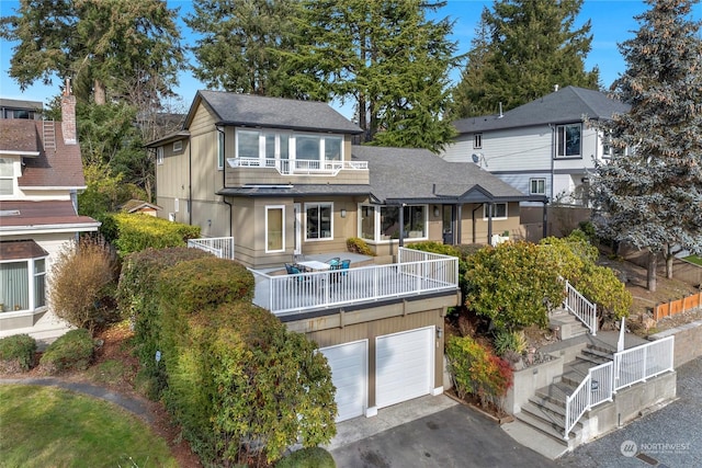 view of front of house with a balcony and a garage