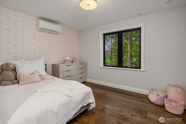 bedroom with dark wood-style flooring, a wall mounted air conditioner, and baseboards