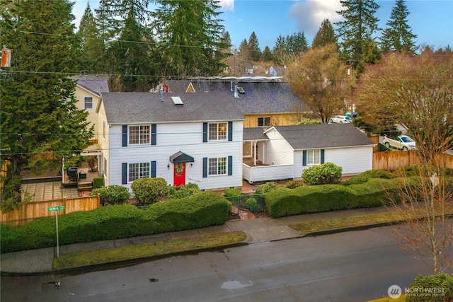 colonial house with roof with shingles and fence