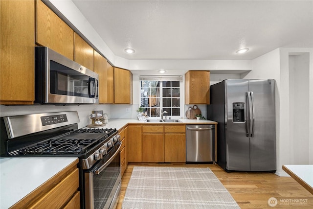 kitchen with appliances with stainless steel finishes, brown cabinets, and light countertops