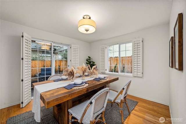 dining room featuring light wood-style floors and baseboards