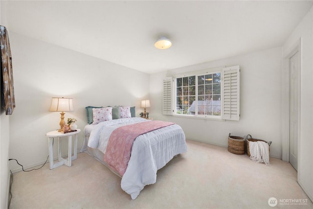 bedroom featuring light carpet