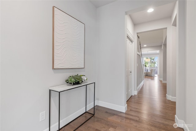 corridor with hardwood / wood-style floors