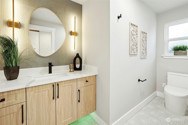 bathroom featuring tile patterned floors, vanity, and toilet