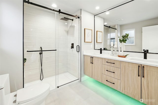 bathroom with vanity, walk in shower, and toilet