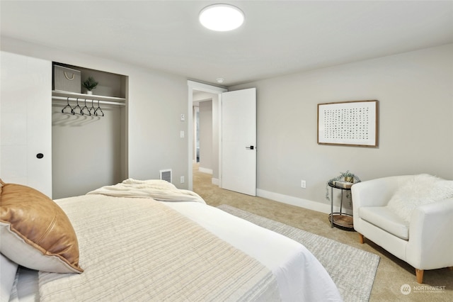 bedroom with light colored carpet and a closet