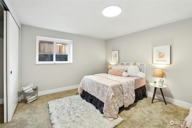 bedroom with light colored carpet and a closet