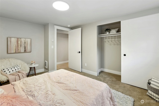 bedroom featuring light colored carpet and a closet