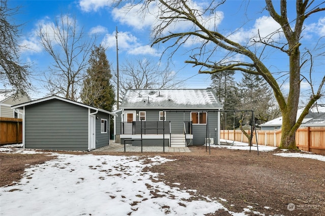 snow covered property featuring a wooden deck