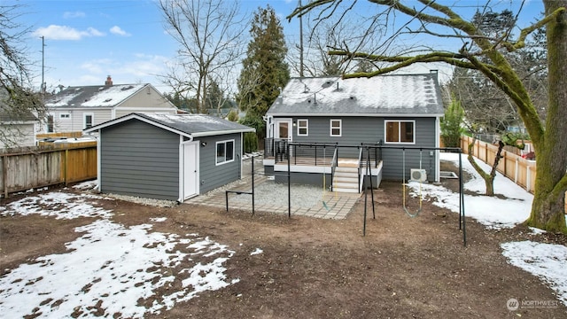 view of snow covered rear of property