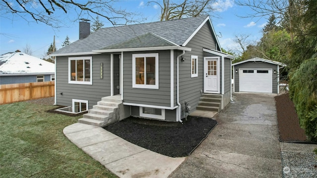 view of front of house featuring a garage, an outdoor structure, and a front lawn