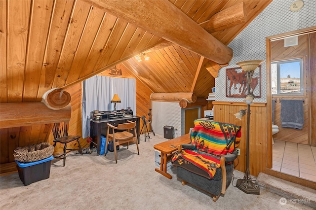 sitting room featuring lofted ceiling with beams, carpet, wooden ceiling, and wood walls