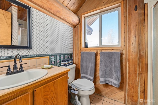 bathroom featuring tile patterned flooring, vanity, and toilet