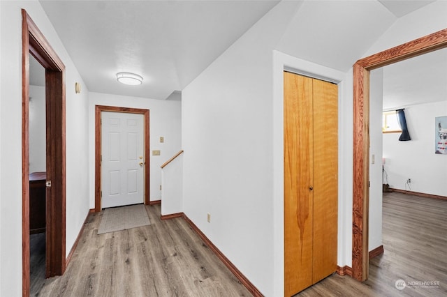 hallway with light hardwood / wood-style floors