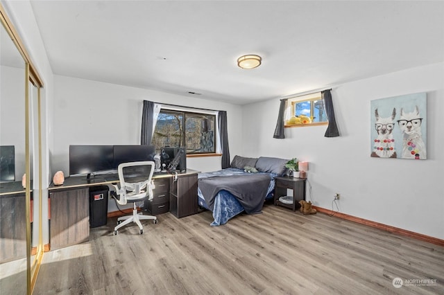 bedroom featuring light hardwood / wood-style floors and a closet