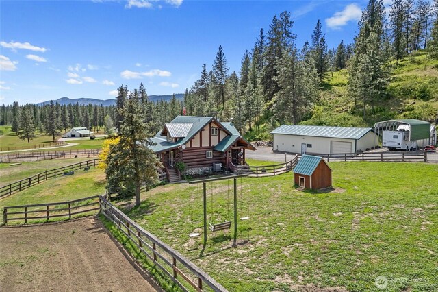 1427 N Chapin Rd, Evans, WA 99126 - view of yard with an outdoor structure, a detached garage, a rural view, a mountain view, and a pole building