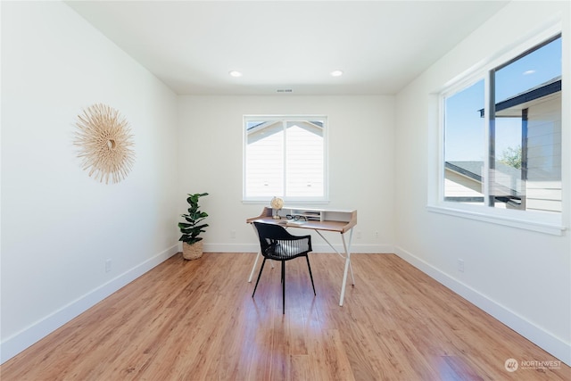 office area featuring plenty of natural light and light hardwood / wood-style flooring