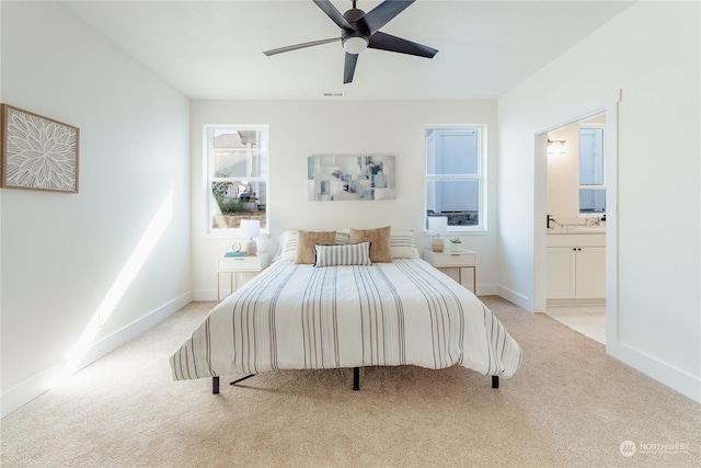 carpeted bedroom featuring connected bathroom and ceiling fan