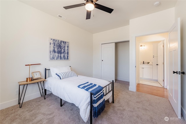 carpeted bedroom featuring ceiling fan and a closet