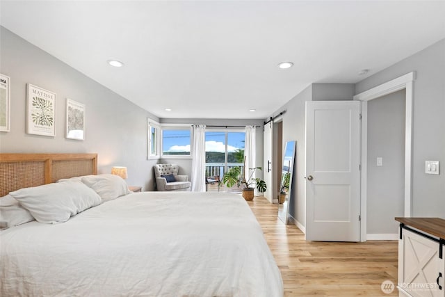 bedroom featuring a barn door, recessed lighting, baseboards, access to outside, and light wood-type flooring