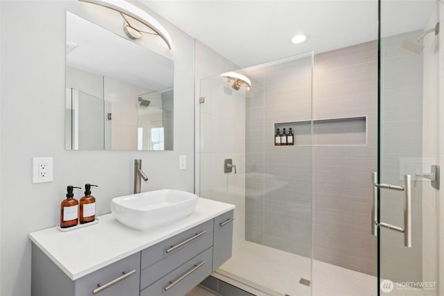 full bathroom with a stall shower and vanity