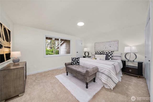 bedroom featuring light colored carpet and baseboards