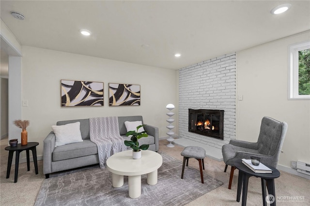 carpeted living area with baseboards, a fireplace, and recessed lighting