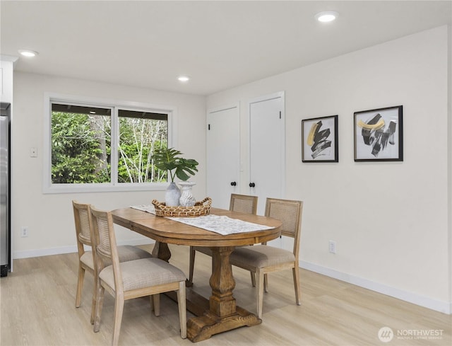 dining room with recessed lighting, light wood-type flooring, and baseboards