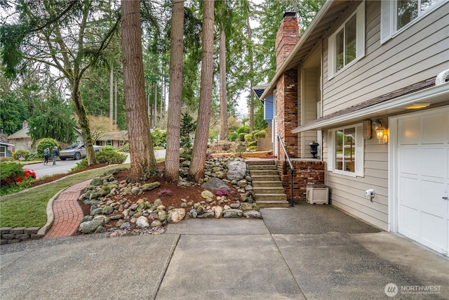 view of patio featuring a garage and stairs