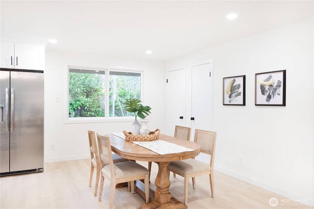 dining room featuring light wood-type flooring, baseboards, and recessed lighting