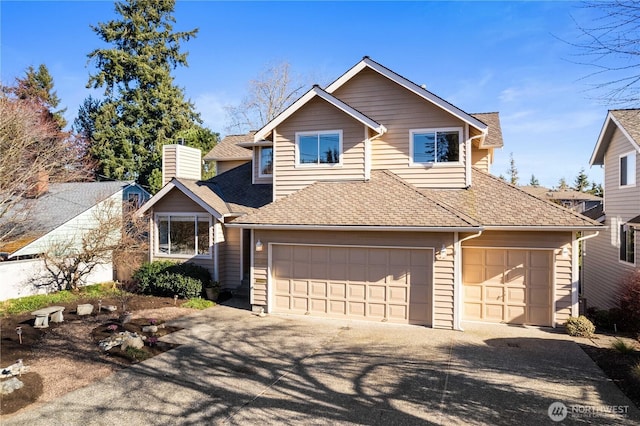 view of front of home with a shingled roof, a chimney, and concrete driveway