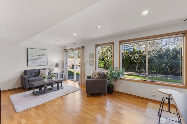 living area with recessed lighting, light wood-style flooring, and baseboards