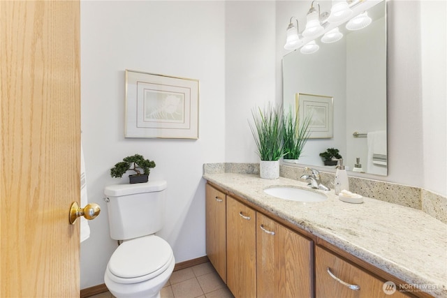 bathroom featuring toilet, baseboards, vanity, and tile patterned floors