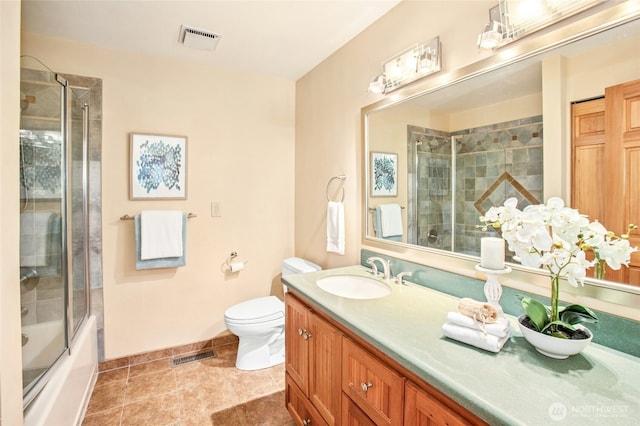 full bathroom with visible vents, toilet, vanity, and shower / bath combination with glass door