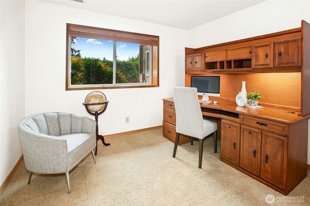 home office featuring baseboards and light colored carpet