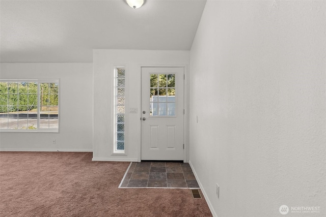 view of carpeted entrance foyer