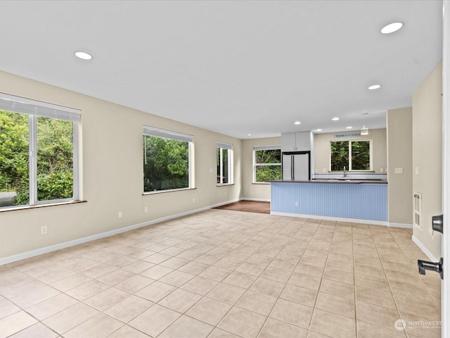 unfurnished living room with sink