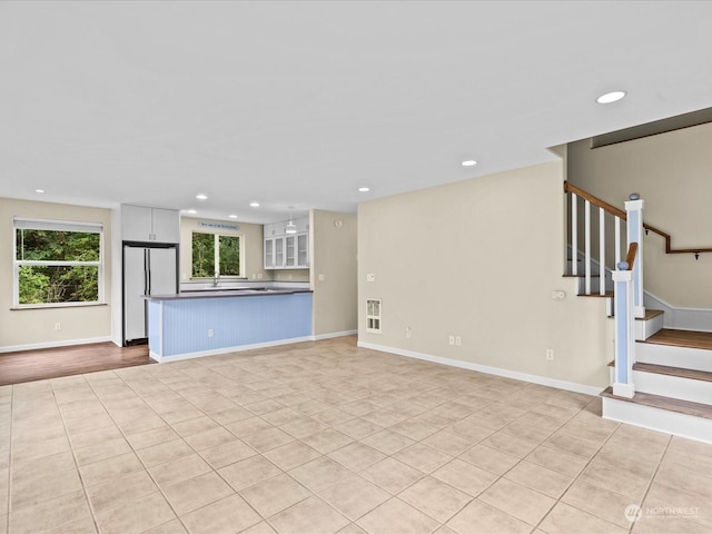 unfurnished living room featuring light tile patterned floors