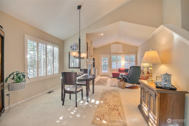 carpeted dining area with a notable chandelier and high vaulted ceiling