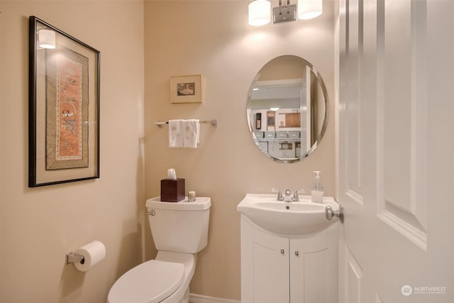 bathroom featuring vanity and toilet