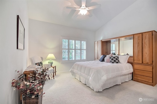 bedroom with vaulted ceiling, light colored carpet, and ceiling fan