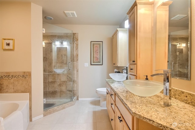 full bathroom with independent shower and bath, vanity, tile patterned floors, and toilet